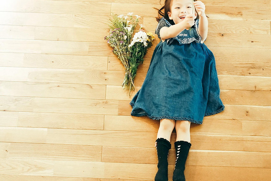 Photograph of a girl lying on the flooring